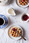 Cornflour and spelt waffles with raspberry jam served with coffee