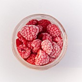 A jar of frozen raspberries