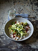 Courgette spiral salad with dried tomatoes and nuts
