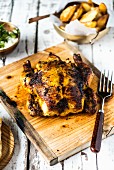 Masala roast chicken on a wooden board