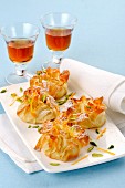 Sweet filo pastry sacks with pistachios and icing sugar served with dessert wine