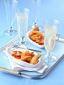 Fried sesame seed prawns with a chilli dip and glasses of champagne
