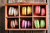 Colourful macaroons in an old wooden box