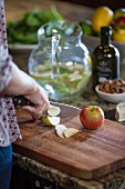 Slicing apples on rustic wooden board