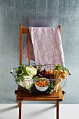 Winter vegetables, figs, and physalis in a wire basket