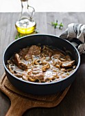 Pork chops with mushroom sauce in a pan