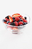 Strawberries, blackberries, raspberries and blueberries in a glass bowl