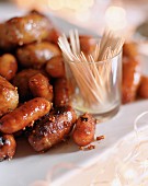 Mustard and honey-glazed cocktail sausages with toothpicks