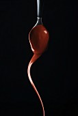 Chocolate dripping from a spoon