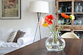 Poppies in glass vase