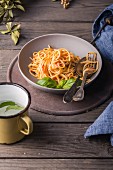 Plate of spaghettis with tomato sauce and basil