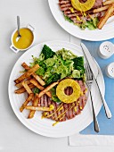 Gammon steak with pineapple, chips and vegetables