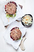 Vegan wholemeal burgers with shredded cabbage, carrots, lettuce and beetroot fritters