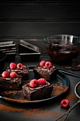 Mini chocolate cakes with raspberries and cocoa powder