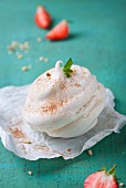 Meringue dessert filled with cream and sprinkled with cinnamon