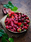 Fresh cherries, strawberries and raspberries in a bowl