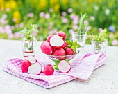 Radishes in a glass bowl and next to it