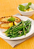 Steamed green beans with pine nuts and lemon juice served with grilled bread with olive oil