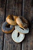 Various bagels on a dark wooden surface
