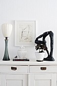 Ornaments and accessories on old white chest of drawers