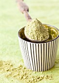 Matcha powder in a bowl and on a spoon