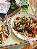 Quick penne pasta with asparagus, cherry tomatoes and peas