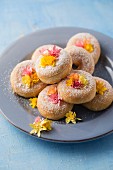 Doughnuts decorated with paper flowers on a plate