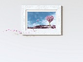 Leaves falling from heart-shaped tree in picture frame, 3D rendering