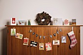 Christmas cards hung on wooden sideboard