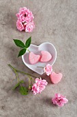 Rose flavour pink sugar hearts in a heart-shaped dish