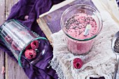 A vegan raspberry smoothie with chia seeds in a glass