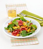 Salad with grilled peaches, beetroot leaves, ham and croutons