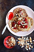 Flourless banana and couscous pancakes with strawberry jam and almonds