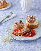 Profiteroles with vanilla ice cream, strawberry and rhubarb compote and elderflowers