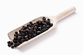Dried blackcurrants on a wooden scoop