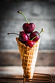 Fresh cherries in an ice cream cone