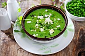 Cream of pea soup with cheese and black sesame seeds