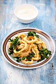 Baked squid rings with fried parsley