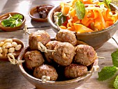 Meatballs with a date, almond and carrot salad