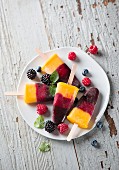 Tri-coloured berry and mango ice lollies