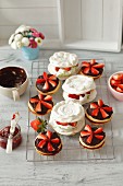 Chocolate sandwich biscuits with strawberry jam, and mini pavlovas with lime whipped cream and strawberries