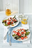 Grilled asparagus with strawberries, feta cheese and orange sauce