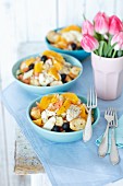 Fish salad with baked cod, black olives, celery, orange, beans and croutons