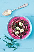 Cold beetroot soup with beetroot leaves, radishes, potatoes, kefir and quail's eggs