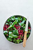 Tender beetroot leaves in a bowl (seen from above)