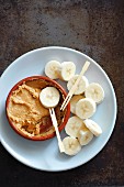 Banana slices with peanut butter for dipping