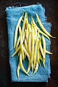 Fresh yellow beans on a cloth (seen from above)
