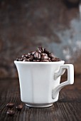 Coffee beans in a white coffee cup