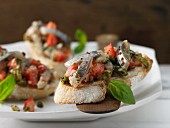 Soused herring and tomato salad on fresh baguette
