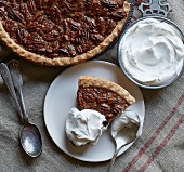 Pecan pie with whipped cream (seen from above)